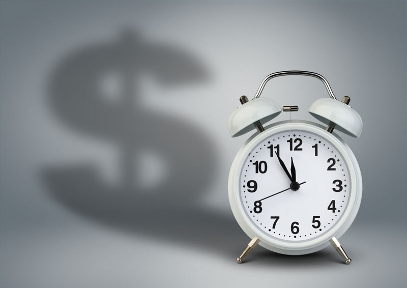 Clock with the shadow of a dollar sign, representing overtime